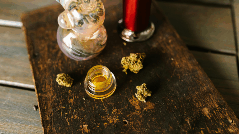 Hemp-derived flower and rosin extract next to a bong